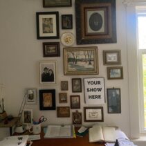 A wall of framed portraits